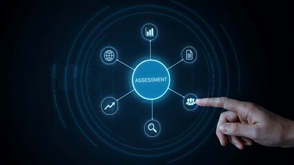 Fototapeta premium A hand reaching out to touch a glowing blue digital interface displaying an assessment concept with various like charts and globes