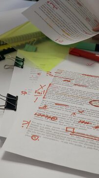 Vertical footage of proofreading and find errors of using artificial intelligence to write texts and books. Editor reviewing texts for accuracy and grammar
