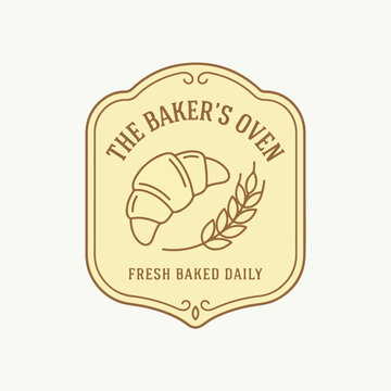 Vintage style bakery logo design with croissant and wheat.