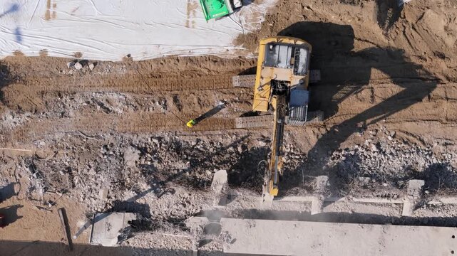 Aerial Drone View of a Heavy Excavator Demolishing a Concrete Bridge Structure for Urban Infrastructure Reconstruction Project