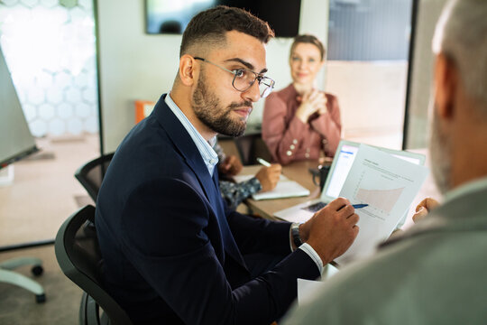 Business team reviewing growth report in modern office