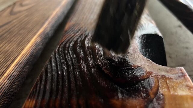Close-Up of Applying Oil Finish to Charred Pine Wood with Brush