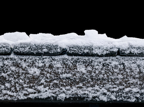 Frosty wooden pier, isolated on a black background.