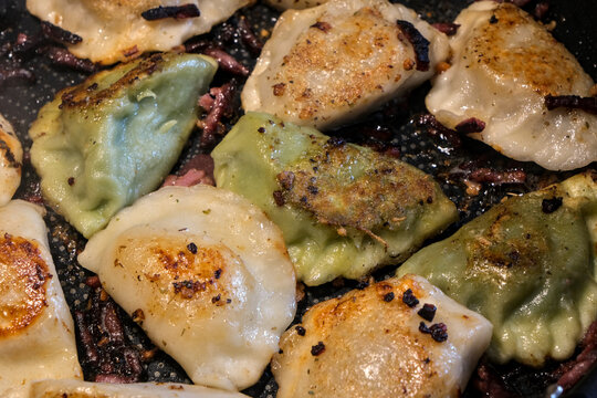 Pan fried pierogi with smoked bacon and smalec, golden and crispy, served hot with a rich traditional Eastern European flavor.