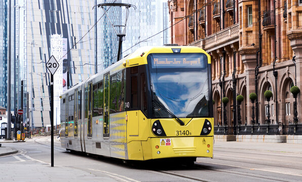 Manchester, England, UK - 18 June 2026: Manchester Metrolink yellow tram, modern city tramway transportation, urban public transit system, electric passenger train on street track in UK