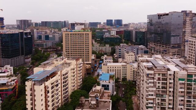 Apartments with glass faded buildings, Feather Roundabout and The Westin Hyderabad Mindspace at Hitec city, madhapur, hyderabad, telangana, india. day time, crane shot, drone shot, 4k.