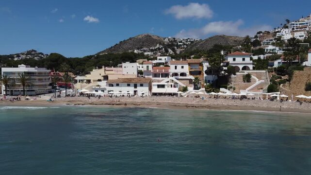 Flying away from Portet cove. Located in Moraira, it is one of the most beautiful and unique beaches on the Costa Blanca. Spain.