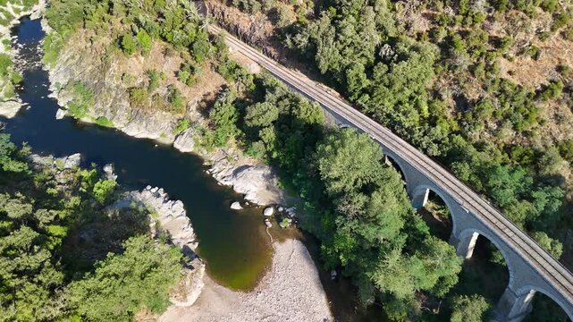 Aerial View of Historic Railway Bridge Crossing the Gardon River in Anduze, France