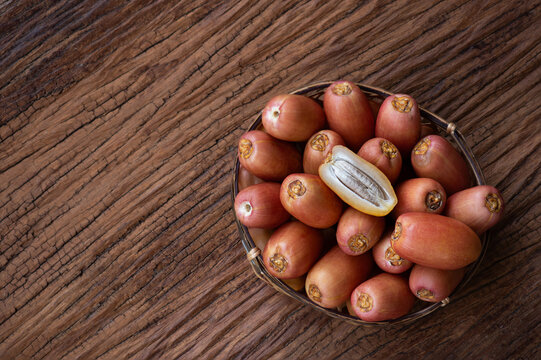 Date palm or Phoenix dactylifera fruits on an old wooden background.top view.