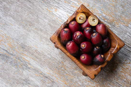 Date palm or Phoenix dactylifera fruits on an old wooden background.top view.