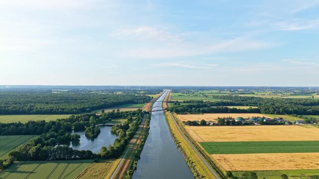 Aerial landscape with river canal among agricultural filed. Canal aerial view. Travel and logistics. River canal aerial 4k footage