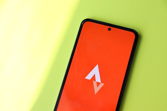 Salvador, Brazil - July 17, 2026: Smartphone displaying the Strava application on the screen on a green background, capturing concepts of fitness tracking and physical activity. Strava logo.