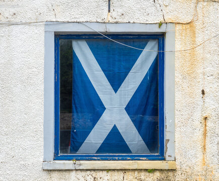 Scottish flag proudly displayed on a window in the city center of Stornoway, Isle of Lewis, Outer Hebrides Islands, Scotland.