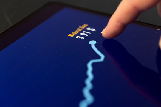 Finger points on a computer screen with rising Brent Crude oil chart, energy commodity data.  Commoditiy investmennt, future contracts, trading, stock market and exchange.