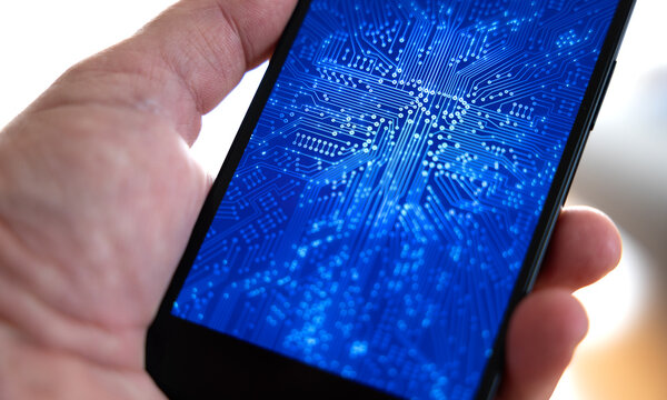 Hand holds a smart phone, digital connections on screen, circuit board, data flow, machine learning, big data. Hardware, equipment, wireless technology, data processing, bit, binary, motherboard