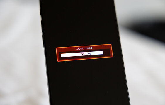 Smart phone screen shows download progress bar, downloading data, software or information. Wireless technology, internet download, status, mobile device, digital asset management, business.