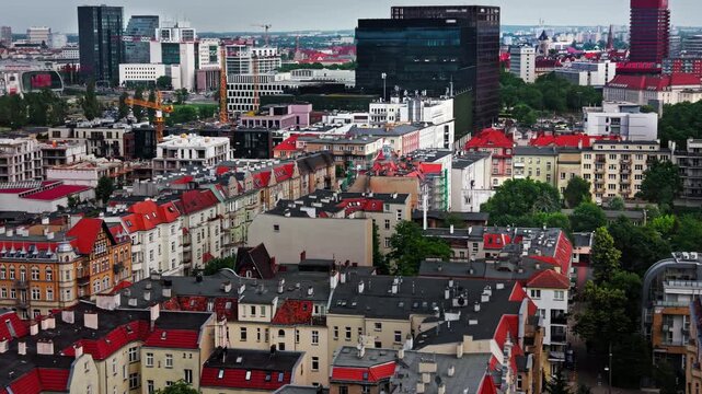 Historic Apartments Rooftop Aerial View city skyline. High angle panoramic drone shot of traditional neighborhood residential buildings featuring classic red tile roofs