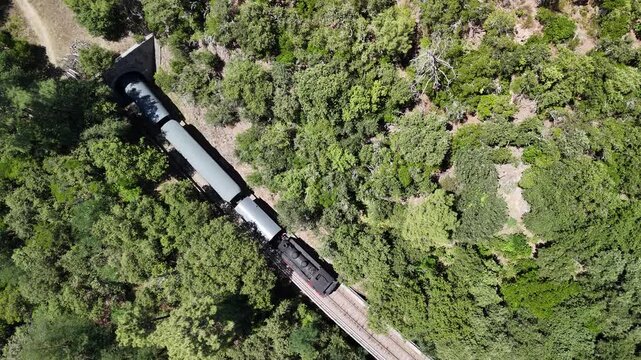 Aerial View of Historic Steam Train Crossing Stone Railway Viaduct near Anduze, France 