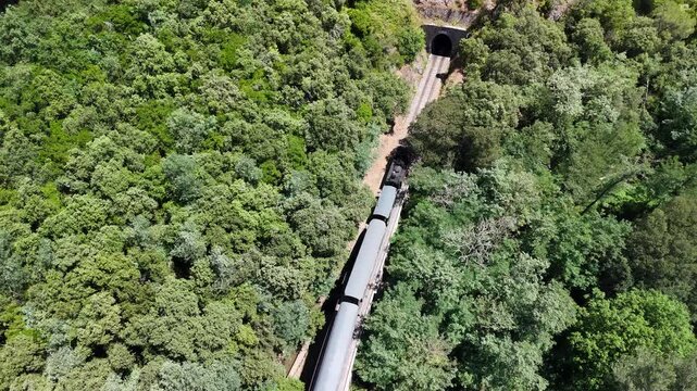 Aerial View of Historic Steam Train Crossing Stone Railway Viaduct near Anduze, France 