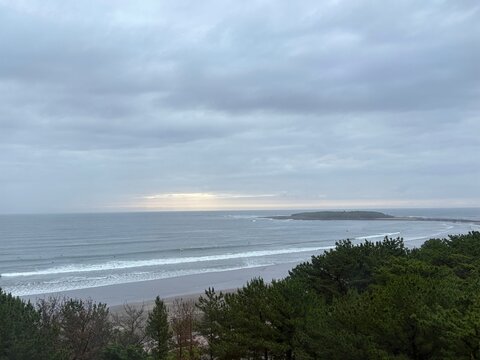 Morning light breaking through clouds over Aoshima Coast, Miyazaki, Japan