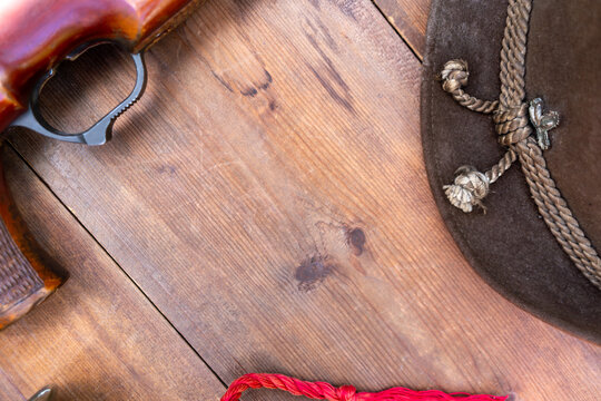 Hunting background for the text.Wooden background with a gun and a hunter's hat.Western.