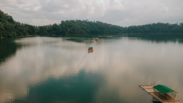 Scenic aerial view of Yambo Lake in Nagcarlan, Laguna, Philippines, with floating bamboo rafts