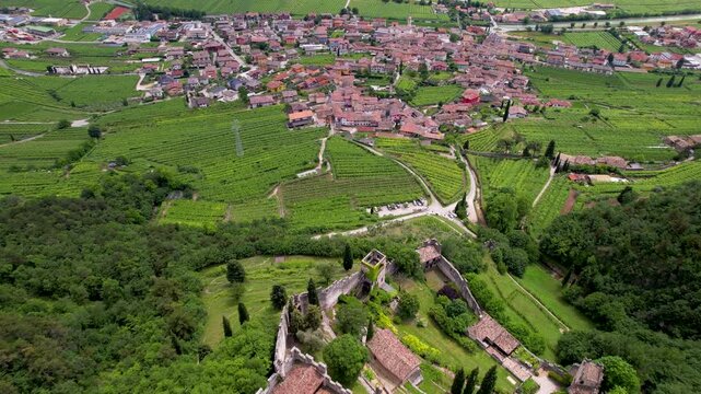 Avio Castle Trentino Italy Aerial Drone Top Down Flight with Tilt Up Reveal of Vineyard Valley and Alps Mountains Medieval Fortress Walled Ruin Historic Landmark B Roll Travel Video 4K
