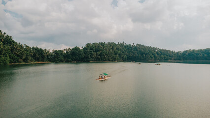 Aerial view of bamboo raft floating on tranquil Yambo Lake in Nagcarlan Laguna Philippines © Gids Stories
