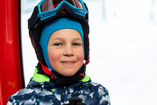 Portrait of cute confident pensive little kid boy enjoy having fun sit ski lift gondola at alpine mountain skiing resort on bright winter day. Toddler beginner skier rest of training in ski school