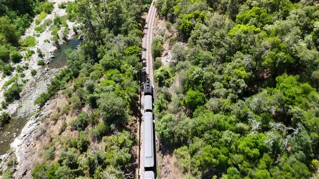 Aerial View of Historic Steam Train Crossing Stone Railway Viaduct near Anduze, France 