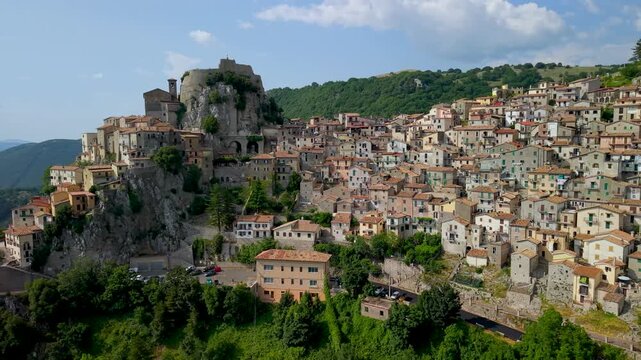 Cervara di Roma Lazio Italy 4k drone view of cliffside village on rocky hill. Sideways flyby flight of cascading stone houses in Simbruini mountains aerial b-roll video, hidden gems near Rome