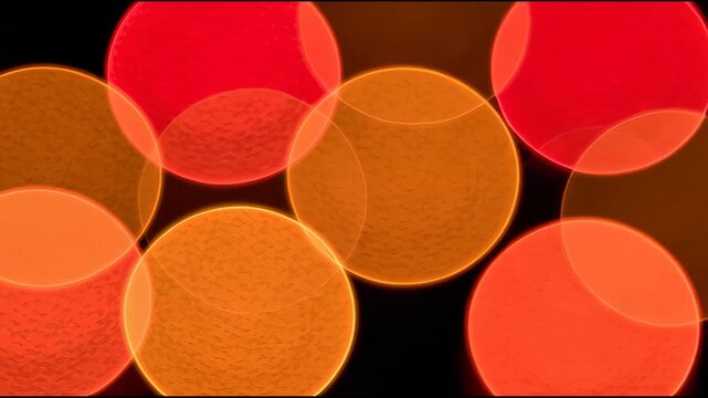 Warm orange bokeh lights glowing softly on dark background, abstract motion background for modern creative design