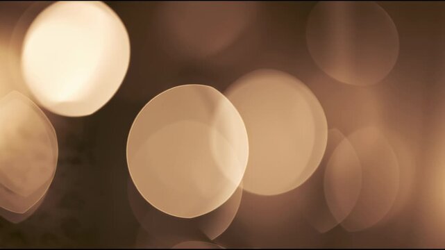 Warm orange bokeh lights glowing softly on dark background, abstract motion background for modern creative design