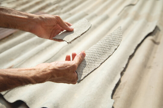 Man showing old asbestos piece. Health problems