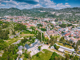 Cetinje historic city, Montenegro, featuring its famous monastery, National Museum, and surrounding mountains under a blue sky