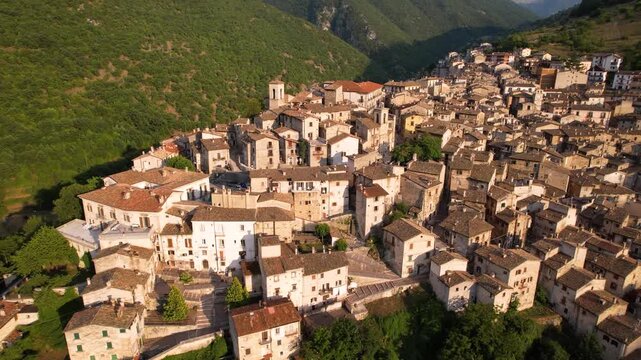 Medieval hiltop town Scanno Abruzzo Italy 4K Drone. Most beautiful italian villages . authentic mountain borgo with sunset sunbeams lens flare. Scenic b-roll cinematic video ,Hidden gems
