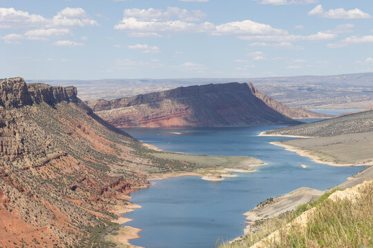 The shadows of puffy white clouds dot the landscape of Flaming Gorge in Northern Utah USA on a sunny summer day.