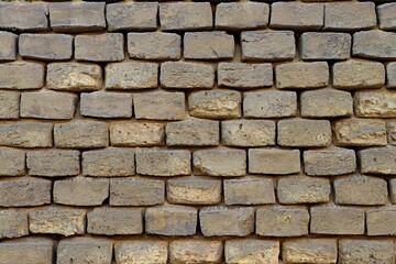 Fototapeta premium Background, texture of a wall made of old light-colored brick covered with a thick layer of dust