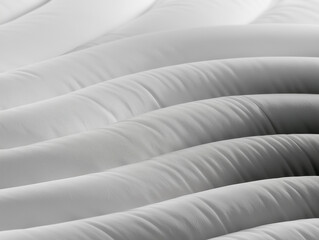 Obraz premium Abstract Close Up Architectural View of White Rippling Padded Fabric Ridges Minimalist Futuristic Wave Textures and Monochromatic Pattern Design