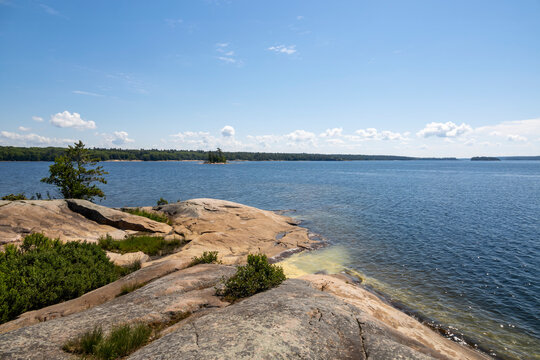 Stunning rocky shoreline and expansive water views from Twin Points Trail at Killbear Provincial Park, Ontario.