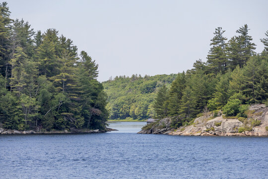 A breathtaking view from the 30,000 Islands cruise from Parry Sound, Ontario, showcasing lush forests and serene waters.