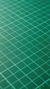 Flat green cutting mat grid, Craft and design workspace background.