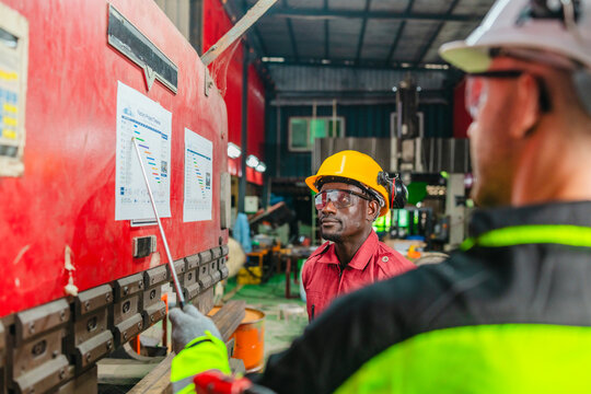 Supervisor Coaches Technician on Sheet Metal Folder Operation and Work Process