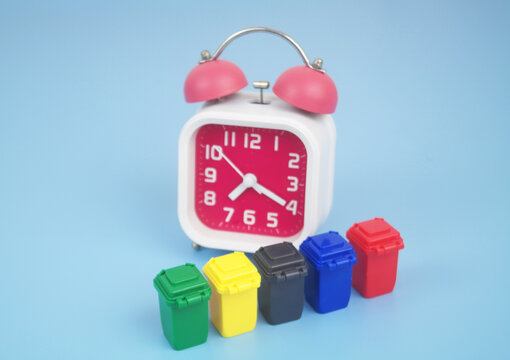 Trash cans and clock on blue background. Сleaning and garbage and trash concept.	