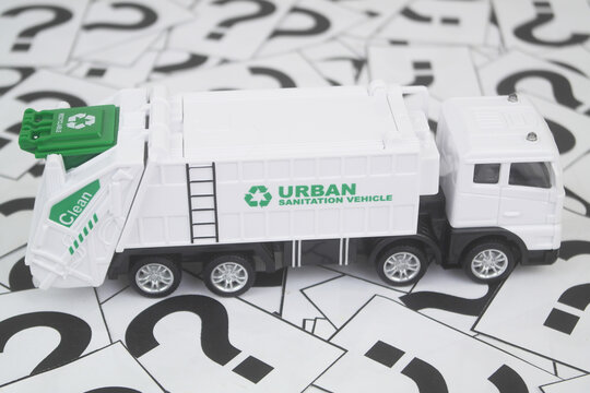 Urban sanitation vehicle on question mark background 