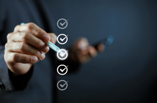 Business professional selecting a checklist with a digital check mark, representing quality assurance, compliance, approval, audit, task completion, productivity, inspection, and workflow management.