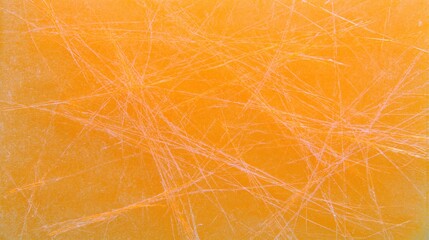 Obraz premium Scratched orange surface with crisscross marks on plain background