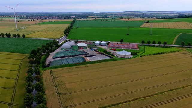 Aerial Video of Biogas Plant, Wind Turbine and Farmland