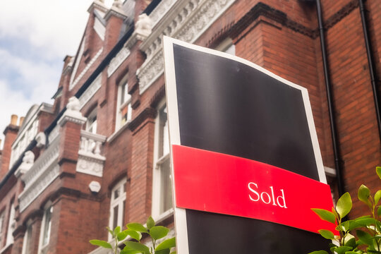LONDON - sold estate agent sign outside red brick residential building