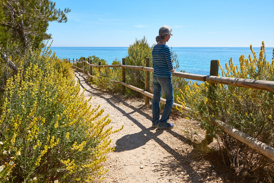 Senior woman in a cami de ronda. Mediterranean sea, Catalonia